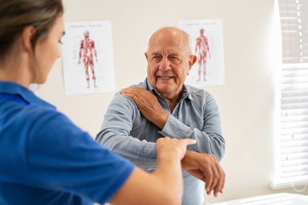 An elderly man getting physiotherapy for his arthritis