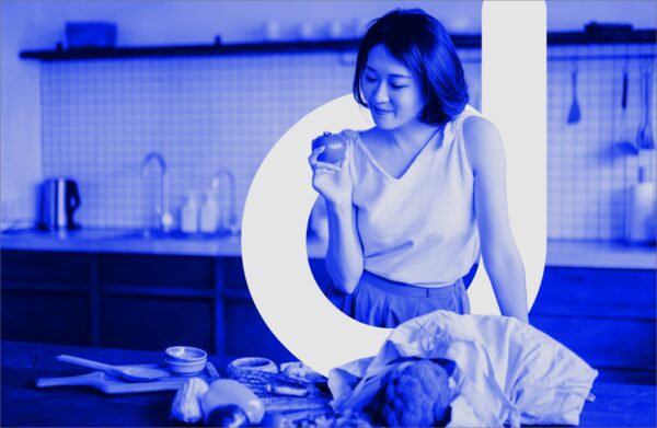 Woman looking at fresh vegetables and letter "d" for "dietitian"