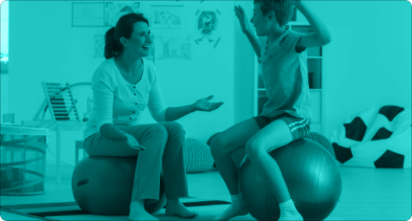 Pediatric physiotherapist working with a young boy