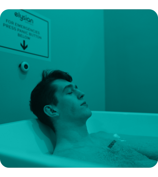 Man with eyes closed in cold plunge therapy tub